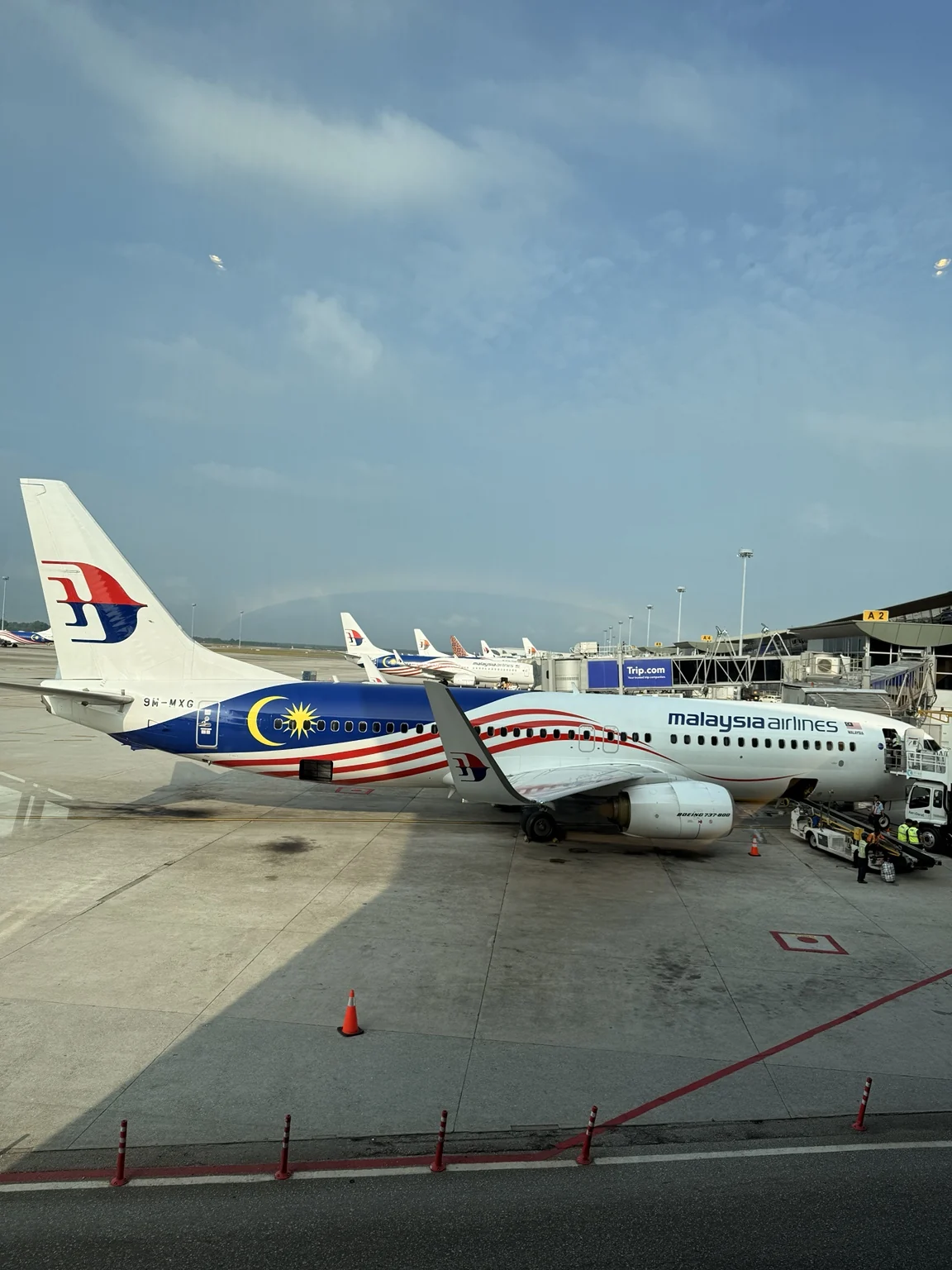 Malaysia Airlines aircraft in Jalur Gemilang livery at an airport gate.